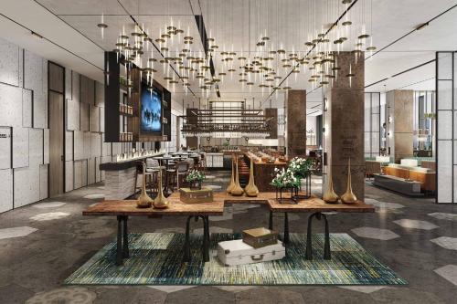 a lobby with tables with potted plants and a chandelier at Four Points by Sheraton Shanghai Hongqiao in Shanghai