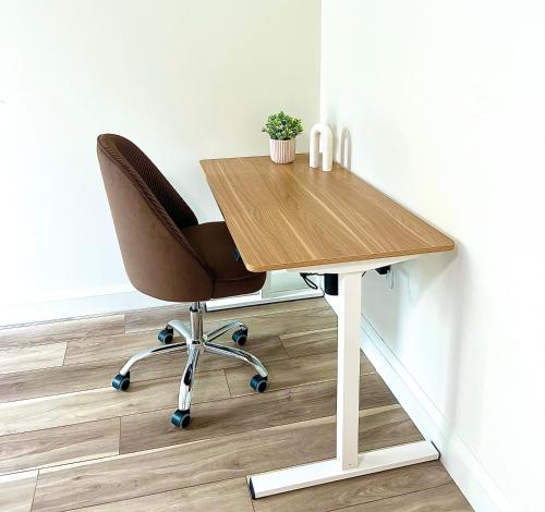 a wooden desk with a chair in a room at Luxury Furnished Apartment in Heart of Quincy in Quincy