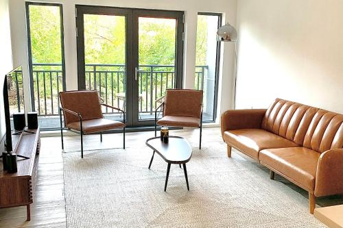 a living room with a couch and chairs at Luxury Furnished Apartment in Heart of Quincy in Quincy