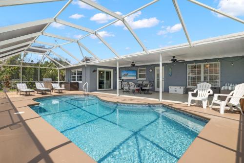 a swimming pool in a house with a glass roof at Little Slice in Cape Coral