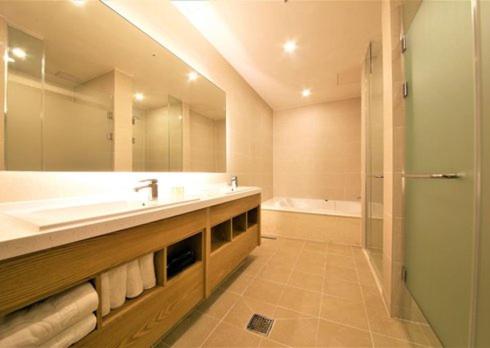 a bathroom with a large sink and a shower at Yangsan Time Square Hotel in Yangsan
