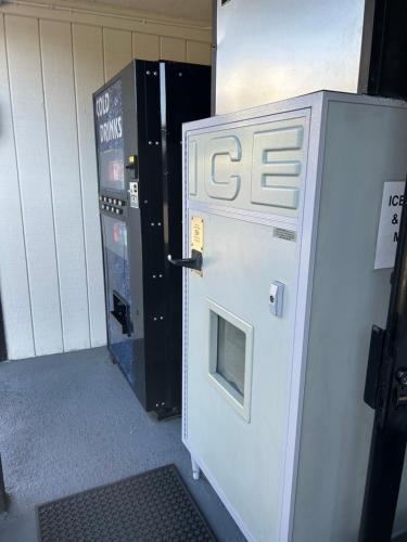 a vending machine next to a ticket machine at Welcome Inn in Los Angeles