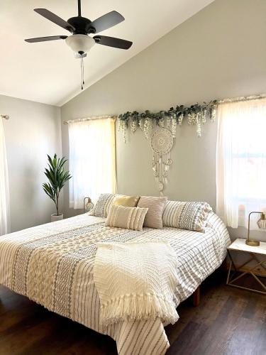 a bedroom with a large bed with a ceiling fan at Almost Heaven Mountain Cabin in Murphy
