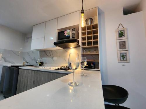 een keuken met twee wijnglazen op een aanrecht bij Apartamento céntrico con suave cama y wifi gratuito! in Cali