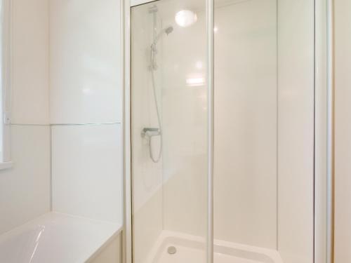 a shower with a glass door in a bathroom at Keepers Wood - W43109 in Bradworthy