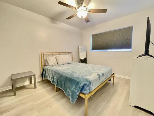 a bedroom with a bed and a ceiling fan at Sandy Beach Sunset East in Clearwater Beach