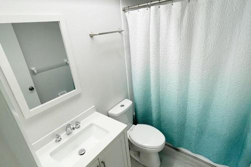 a bathroom with a toilet and a sink and a shower at Beachside Getaway East in Clearwater Beach