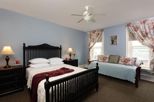 a bedroom with two beds and a ceiling fan at Carlisle House Bed and Breakfast in Carlisle