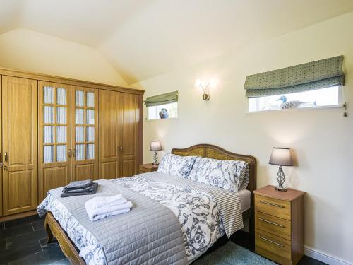 a bedroom with a bed with towels on it at Orchard View in Minsterley