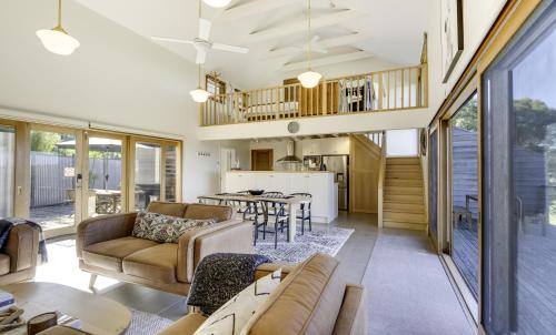 a living room with a couch and a table at Seascape Retreat in Victor Harbor