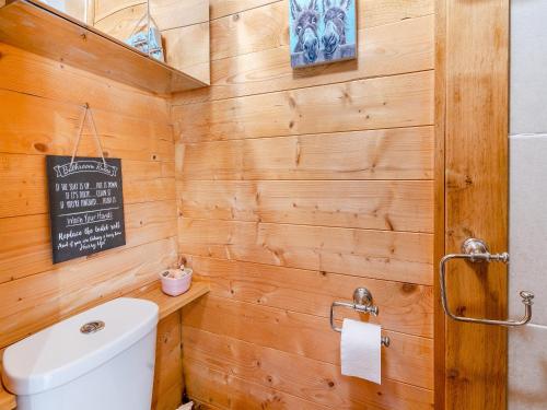 a bathroom with a toilet and a sign on the wall at The Summer House - Uk45102 in Hoel-galed