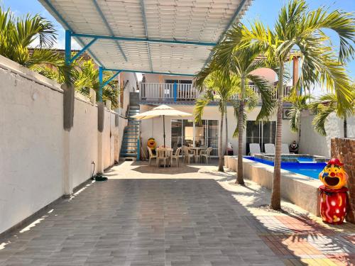 a house with a swimming pool and palm trees at Casa Halley #4 con vista al mar y piscina , 2 pisos - Villamil Playas , Data de Villamil in Playas