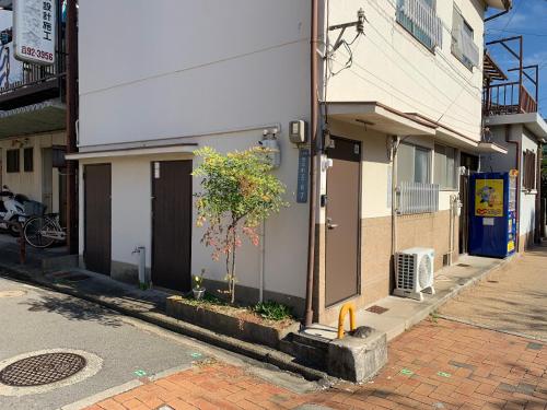 a building on the side of a street at 1F SAKURA RIVER HOUSE, yao 桜と川の家 1F in Yaochō