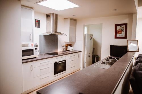 a kitchen with white cabinets and a counter top at True Blue One in Sheffield