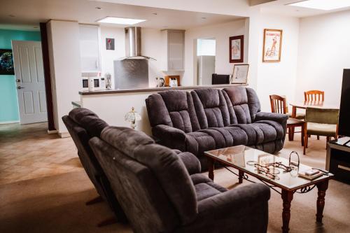 a living room with two couches and a table at True Blue One in Sheffield