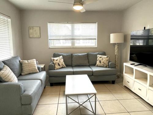 a living room with a couch and a table at Sun, Sand, Coastal Haven 3 in Clearwater Beach