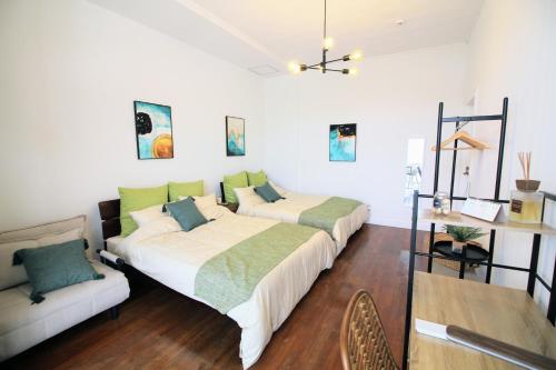 Ένα ή περισσότερα κρεβάτια σε δωμάτιο στο Guest room MINAMI 沖縄
