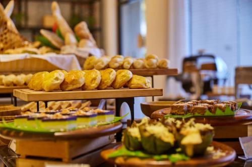 a buffet of food with bread and pastries on plates at Mella Hotel in Manila