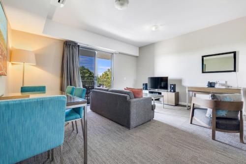 a living room with a couch and a table at Hudson Berrimah in Darwin