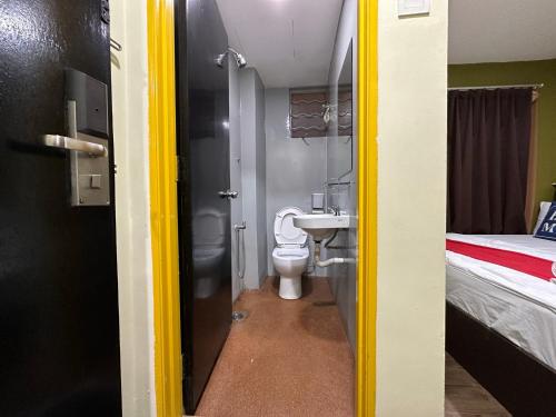 a bathroom with a sink and a toilet in a room at Hotel MSP in Kuala Lumpur