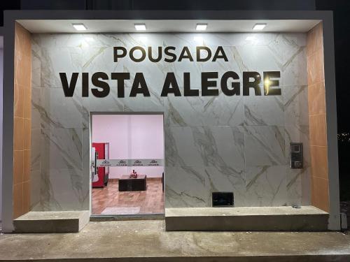 a sign for a vista alberge store at Pousada vista alegre in Itaberaba