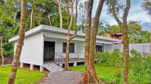 a white house in the woods with trees at Monteverde Magic Mountain in Monteverde Costa Rica