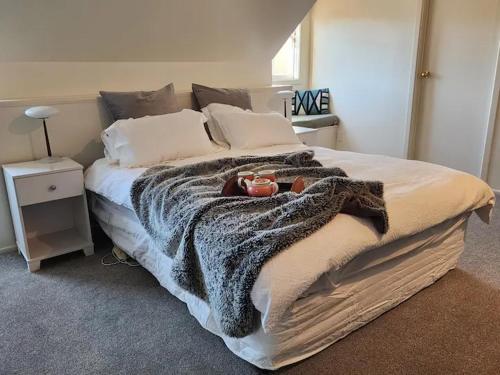 a bedroom with a large bed with a blanket at The Loft @ Gladstone Vineyard in Gladstone