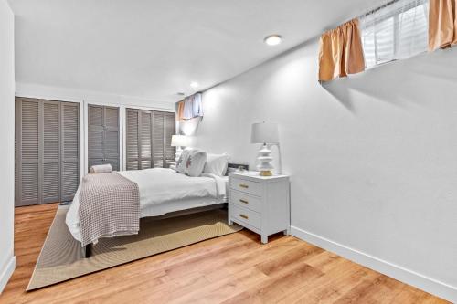 a white bedroom with a bed and a white dresser at 204 High Pkwy - Golden in Golden