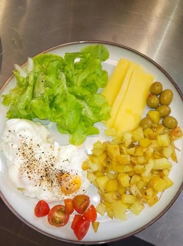 a plate of food with eggs cheese and vegetables at Ampersand Resort in Bophut 