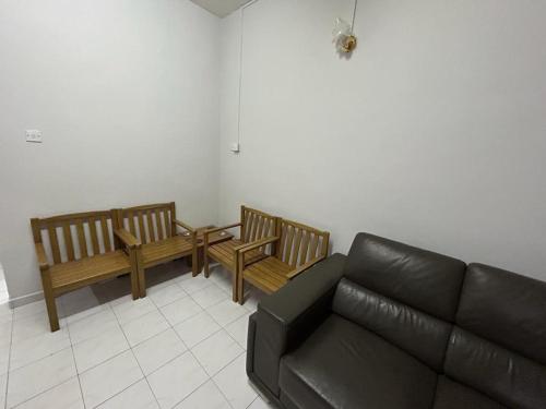 a living room with two benches and a couch at Muhibbah Homestay in Sungai Siput