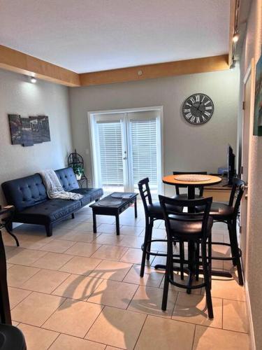 a living room with a couch and a table and chairs at Elegant Condo - European Charm in Palm Coast