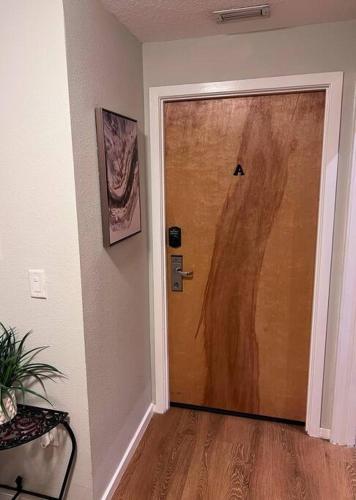a wooden door in a room with a wooden floor at Elegant Condo - European Charm in Palm Coast
