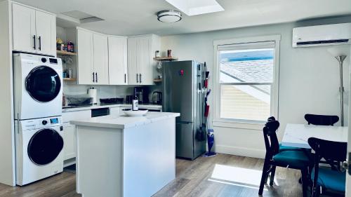 a kitchen with a refrigerator and a table with chairs at Tacoma 2 bedrooms 1 baths sleep 5 with compact kitchen in Tacoma