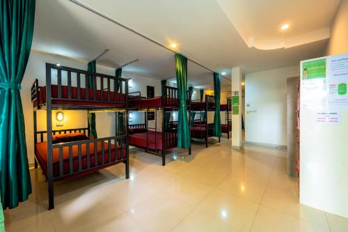 a room with two bunk beds and a room with a room at Samui Backpacker Hotel in Bang Rak Beach
