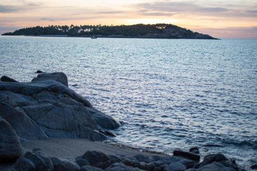 an island in the middle of a large body of water at Ampersand Resort in Bophut 