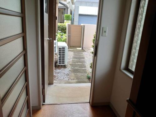 an open door of a house with a hallway at 眺めのいい一軒家 in Tokyo