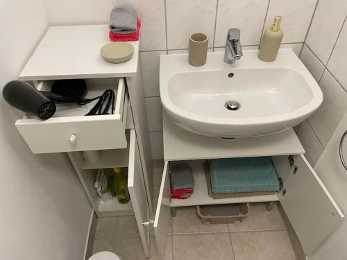 a bathroom with a sink and a toilet and a sink at Comfortable apartment in commercial centre in Unterhaching