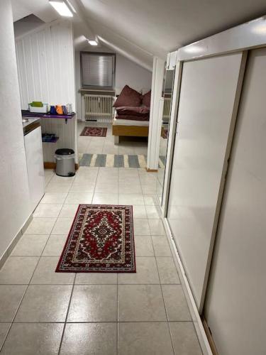 a living room with a rug on the floor at Comfortable apartment in commercial centre in Unterhaching