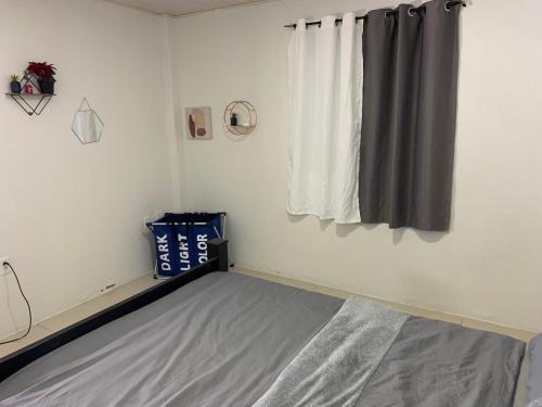 a bedroom with a bed and a window at Relaxing 2 bedroom property for up to 4 person in Georgetown