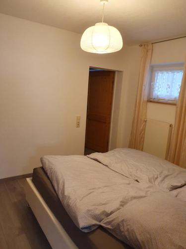 a bed in a bedroom with a light at Ferienwohnung-Pera in Andernach