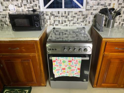 a kitchen with a stove with a towel on the oven at Relaxing 2 bedroom property for up to 4 person in Georgetown