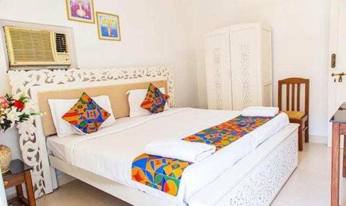 a bedroom with a large white bed in a room at Hotel Toro Highland Beach Resort With Pool - 500M From Candolim Beach in Candolim