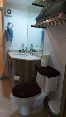 a bathroom with a sink and a toilet and a mirror at Paradise apartment, private beach condo Bay View Grand in Puerto Vallarta