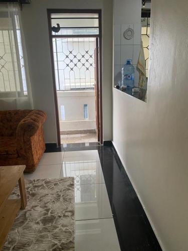 a living room with a couch and a window at Lux Suites JSB Apartments Bamburi in Bamburi