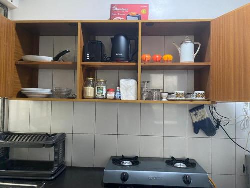 a kitchen with a stove top in a kitchen at Lux Suites JSB Apartments Bamburi in Bamburi