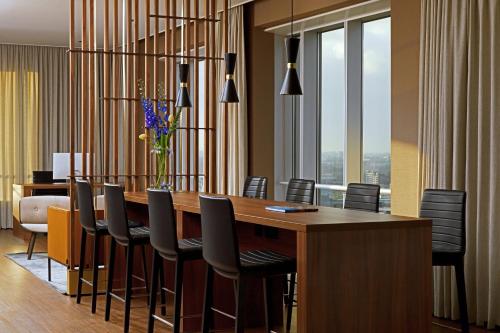 a dining room with a long table and chairs at Rotterdam Marriott Hotel in Rotterdam