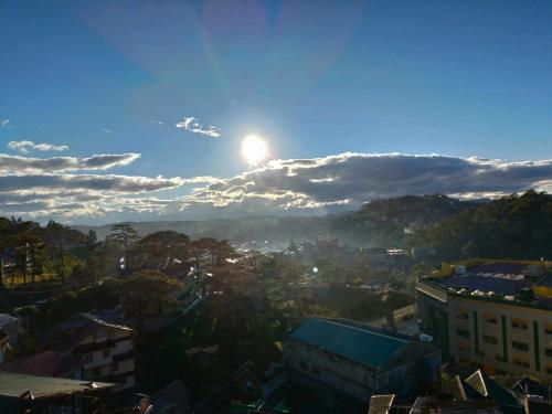 a view of a city with the sun in the sky at EMILIEZ PLACE in Baguio
