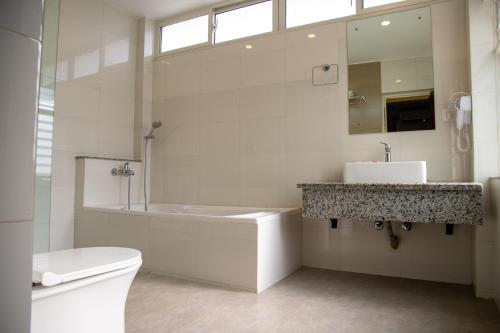 a bathroom with a tub and a sink and a toilet at Hotel Dreams Connect GRB 2 in Kathmandu