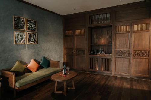 a living room with a couch and a table at Amour Resort Bavi in Hanoi