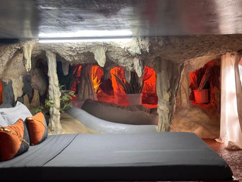 a room with a cave with a bed in it at Gratum Beach Resort in Dapitan